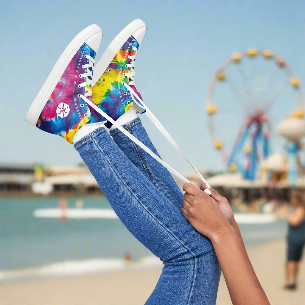 Girl tying her high-top sneakers that have a cool tie dye pattern and a sand dollar on the side