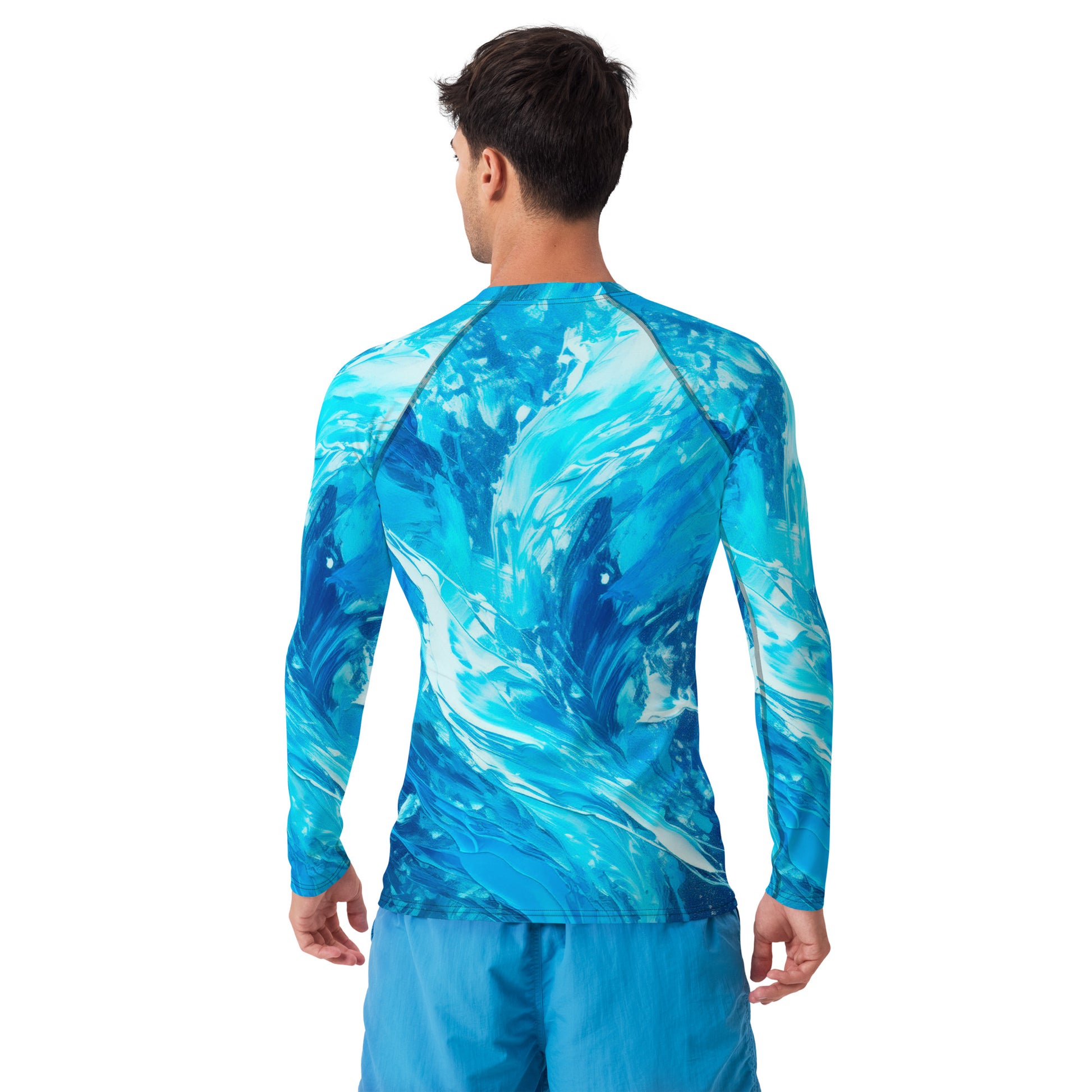 Man wearing a blue wave-patterned men's rash guard, showcasing vibrant UPF 50+ sun protection fabric.