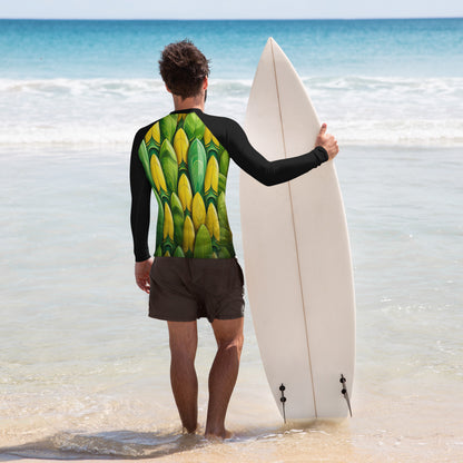 Man in a rash guard with a vibrant surfboard pattern, holding a surfboard on the beach. Perfect for stylish wave-catching!