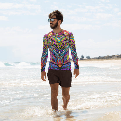 Stylish man in a colorful Mad Abstract rash guard walking along the beach, showcasing vibrant patterns and UV protection.